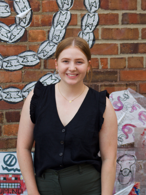 Ava Hohn in front of brick wall