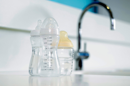 Baby bottles near faucet