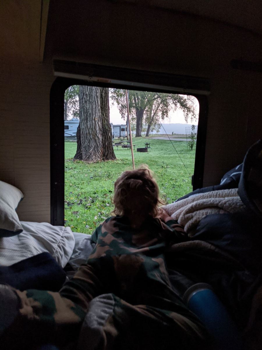 Boy peeking out camper window