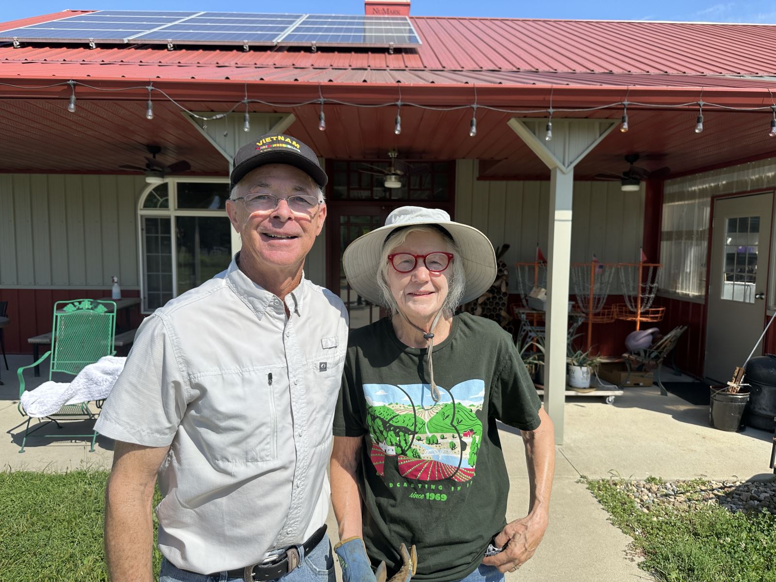Ray and Sue in front of the outbuilding at Cherry Glen Learning Farm.