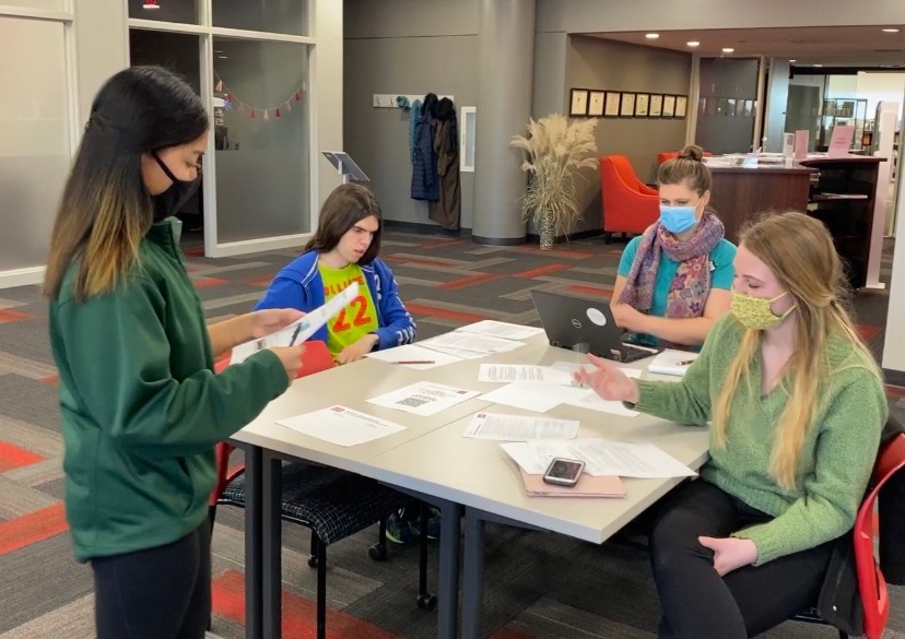 Attendees work on letters with Rashidi of IEC at MLK Day at Central College