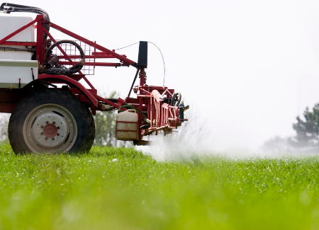 Vehicle spraying a field