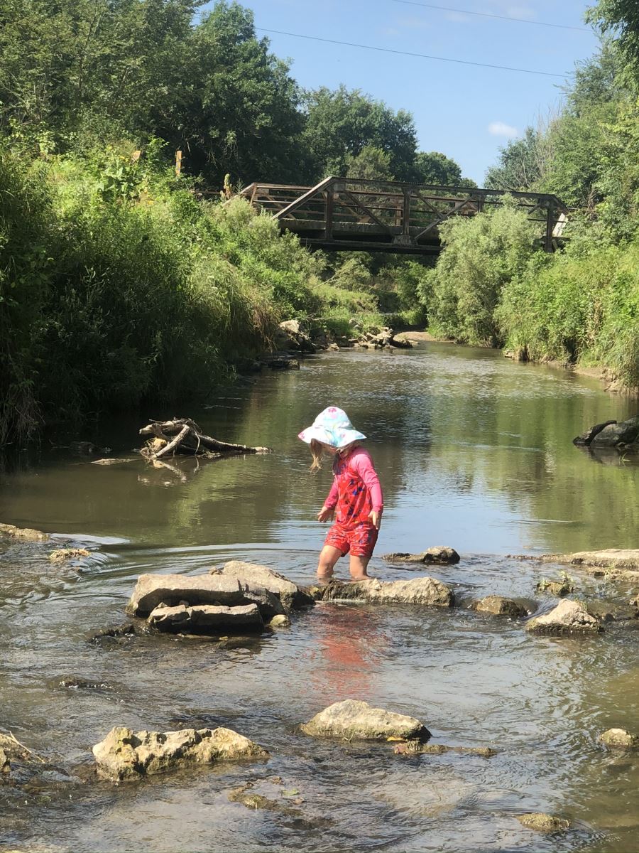 Little girl playing in the Volga River