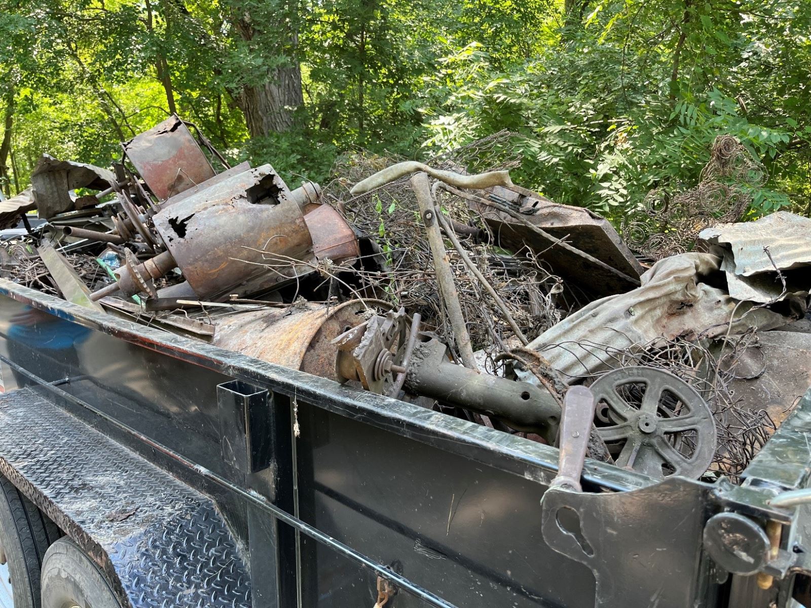 loaded scrap metal trailers filled by Iowa Project AWARE volunteers